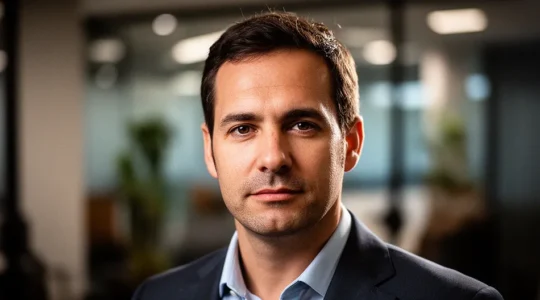 Business professional analyzing data visualizations on interactive dashboard displaying various charts and metrics